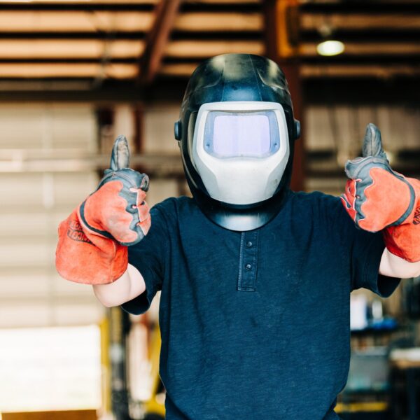 a-child-wears-a-welding-helmet-and-welding-gloves-2024-09-12-21-31-44-utc