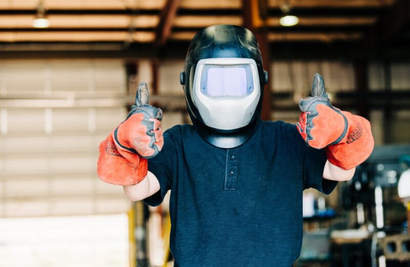 a-child-wears-a-welding-helmet-and-welding-gloves-2024-09-12-21-31-44-utc