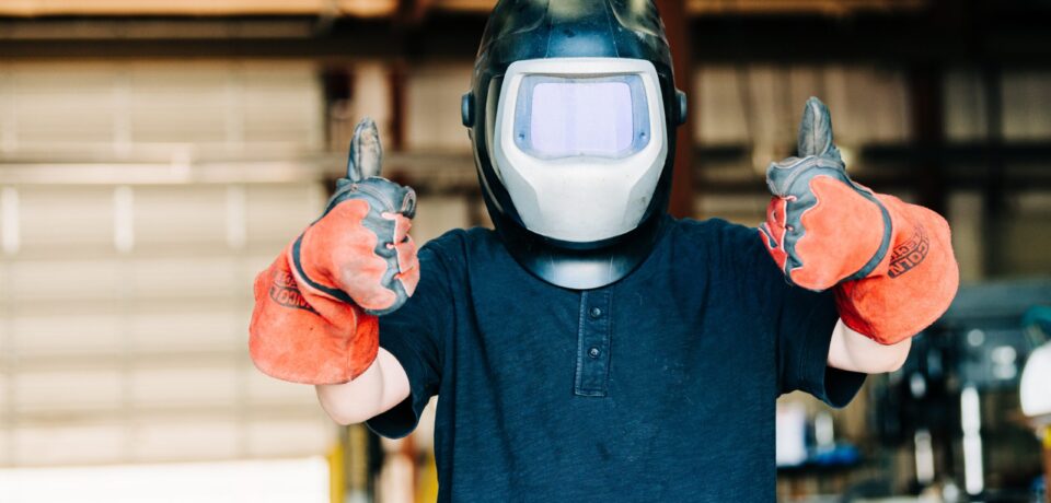 a-child-wears-a-welding-helmet-and-welding-gloves-2024-09-12-21-31-44-utc a-child-wears-a-welding-helmet-and-welding-gloves-2024-09-12-21-31-44-utc