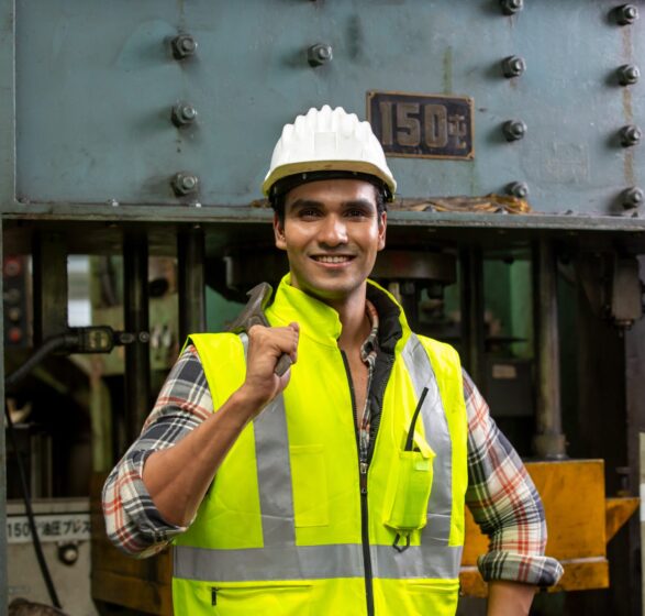 Industrial worker operating cnc turning machine in metal machining industry Industrial Engineers in Hard Hats.Work at the Heavy Industry Manufacturing Factory.industrial worker indoors in factory.aged man working in an industrial