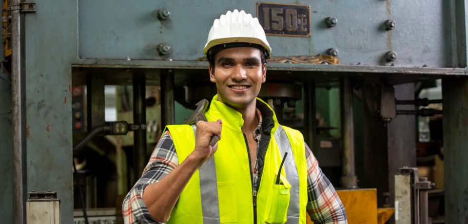Industrial worker operating cnc turning machine in metal machining industry Industrial Engineers in Hard Hats.Work at the Heavy Industry Manufacturing Factory.industrial worker indoors in factory.aged man working in an industrial